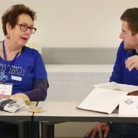 A alumna from the class of '68 and another alumnus enjoy conversation at the Luncheon.